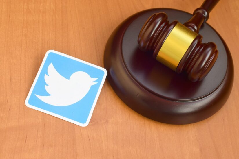 Judges Hammer And A Twitter Logo Cutout On A Table